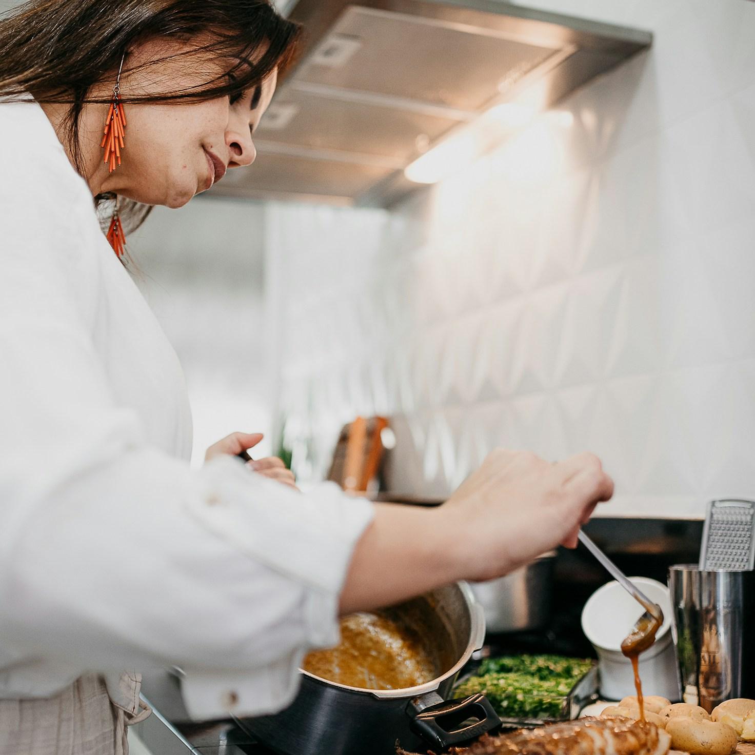 Community members working together in a contemporary kitchen, swapping recipes and techniques